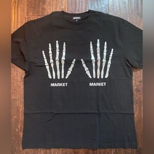 Market branded black t-shirt features reflective skeleton hands on the front